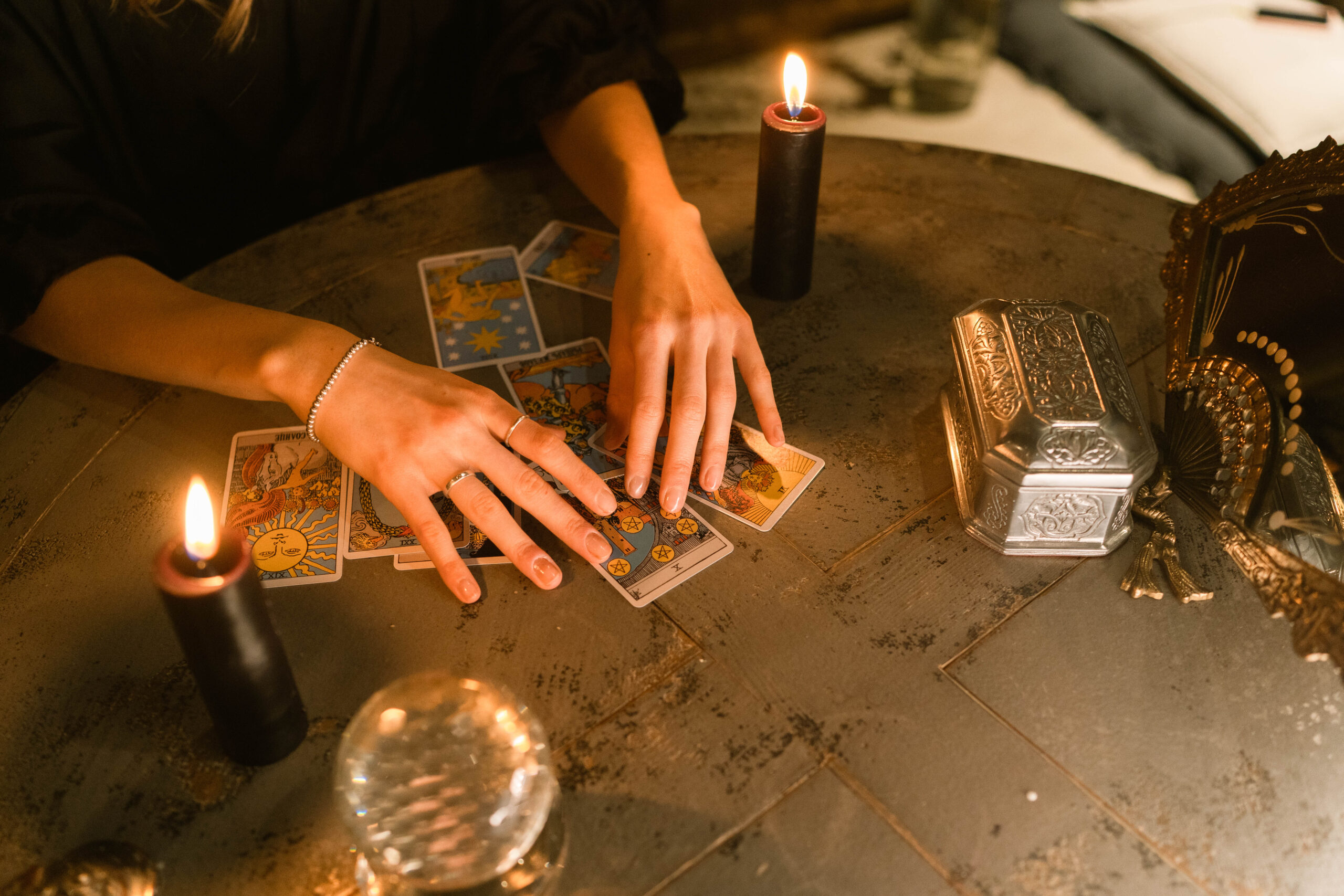 Person holding tarot cards for free witches starter kit