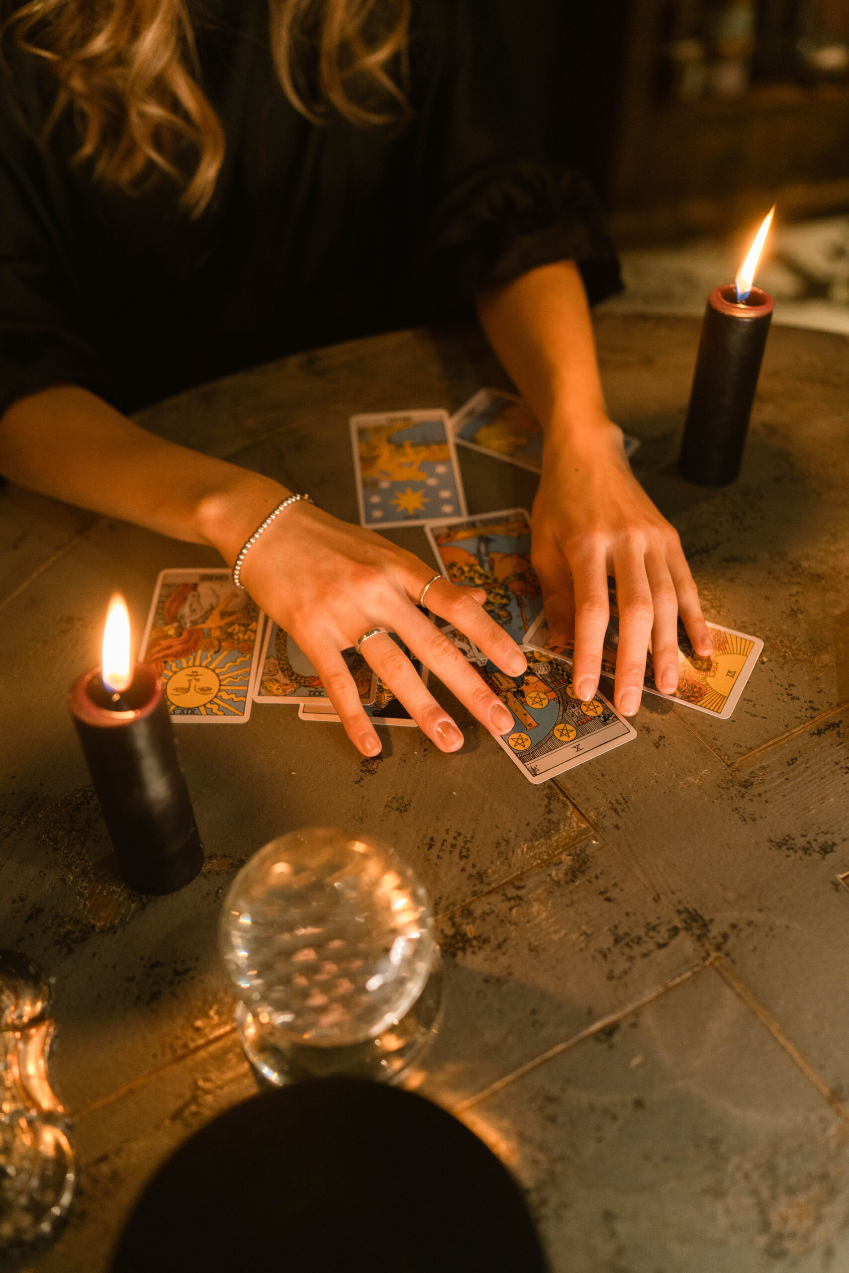 Person holding lighter and tarot cards
