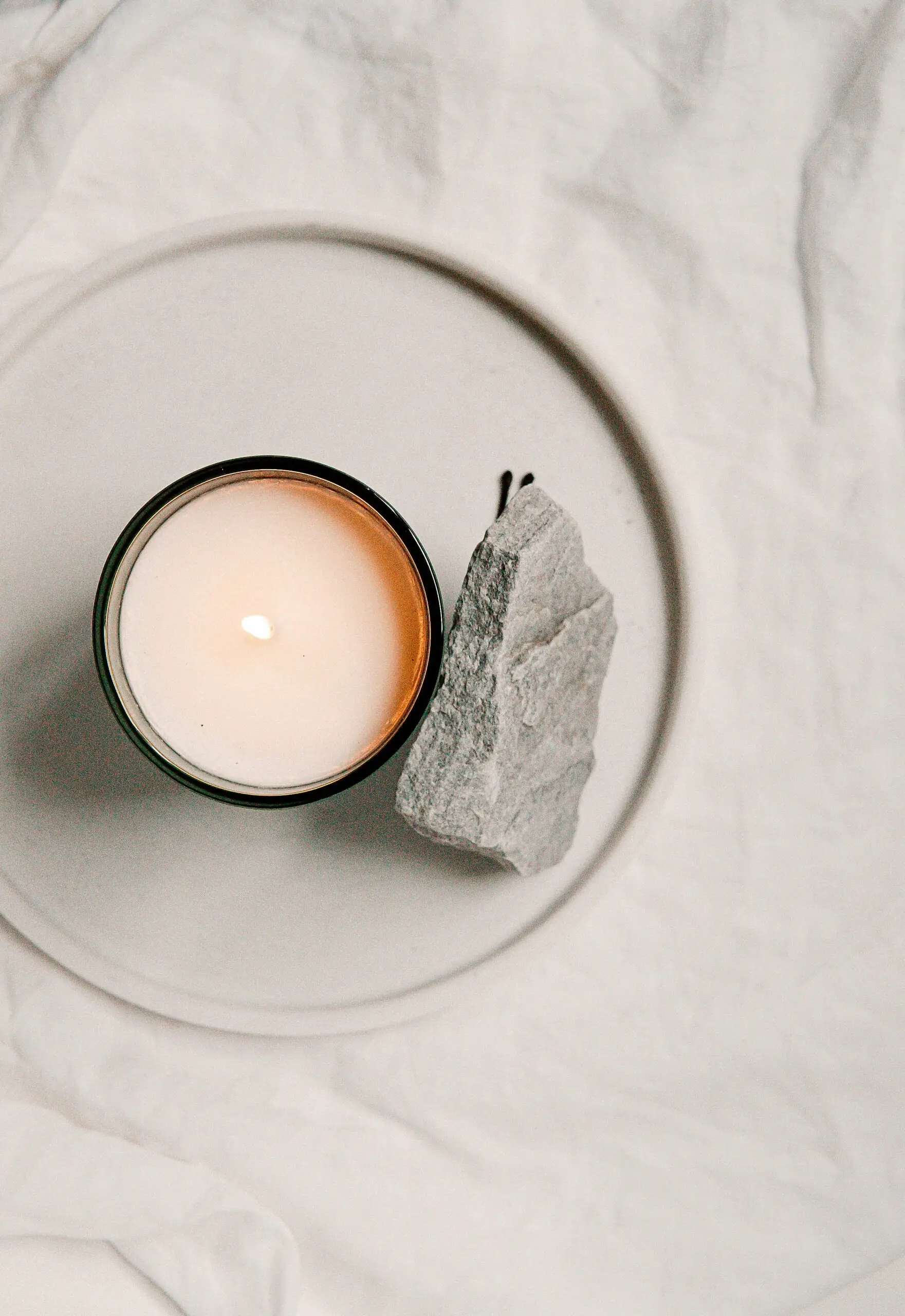white candle and rose quarts could help lighten your mood